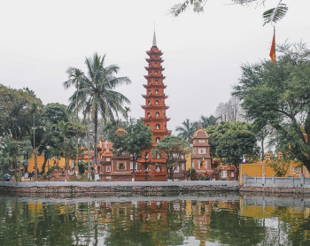 Vietnamese temple with detailed carvings and green plants
